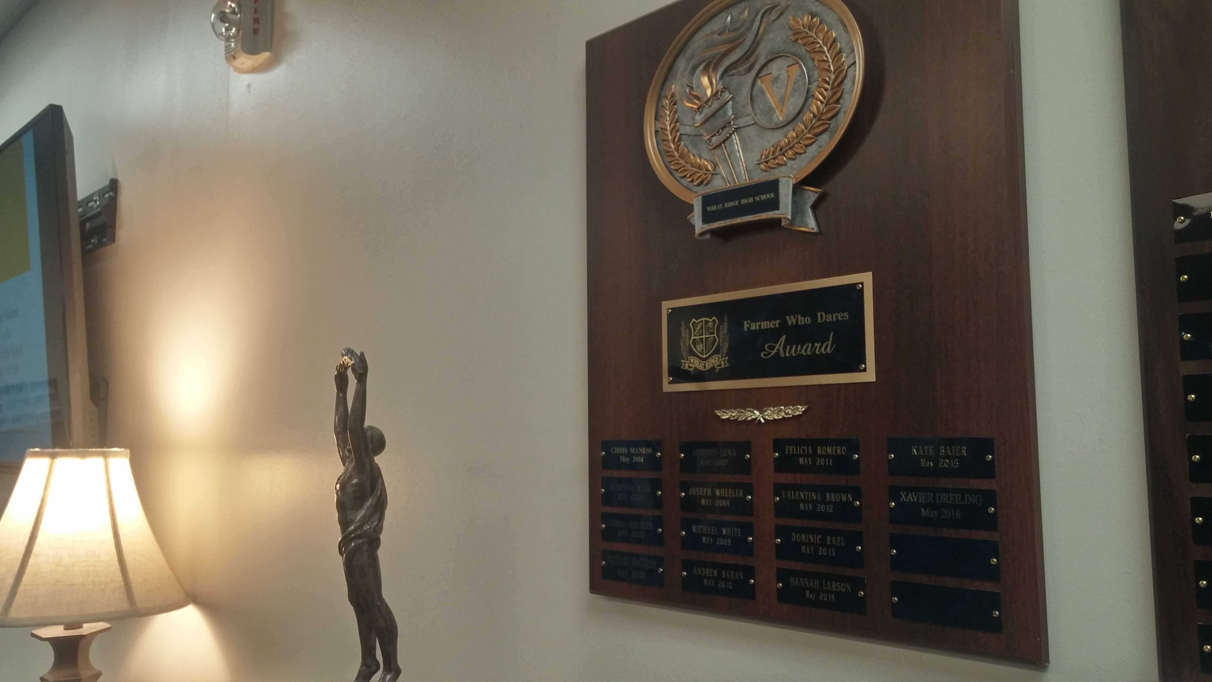 The plaque in the main office that lists past recipients of the Farmer Who Dares Award By Rachel Vigil
