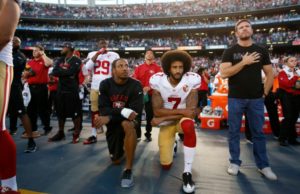 Colin Kaepernick kneeling at a football game during the anthem. courtesy of complex.com