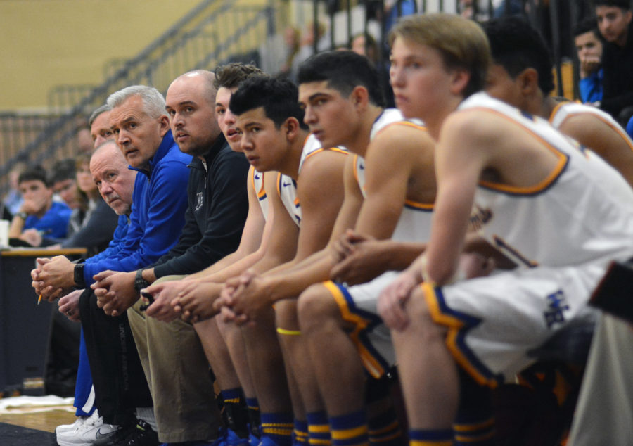 Coach Coach Dowd and boys basketball team during a game.