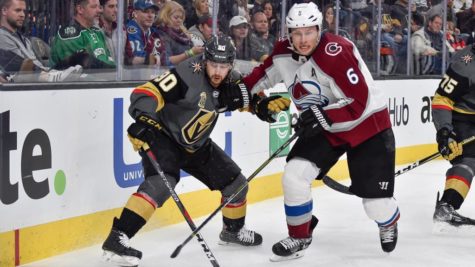 Avalanche defenseman Erik Johnson battles Vegas Golden Knights forward Tomas Tatar for puck possession