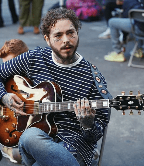 Post Malone playing the guitar.