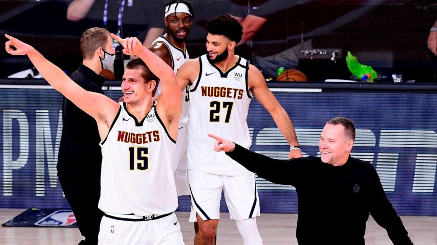 Nuggets%2C+Jamal+Murray+%2827%29%2C+Nikola+Jokic+%2815%29+and+their+head+coach+Mike+Malone+celebrate+after+game+seven+victory.