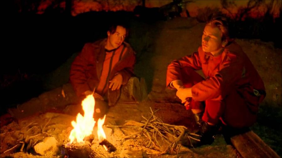 Screenshot of the pivotal campfire scene in My Own Private Idaho, featuring Keanu Reeves and River Phoenix. 